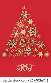 Christmas tree concept shape with joy sign, gold star snowflake, sphere decorations on red background. Icon symbol for the Xmas holiday season.  