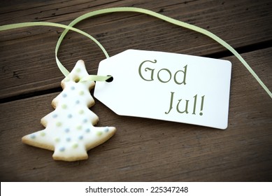 A Christmas Tree Cookie with a Label with the swedish or norwegian Words God Jul on it which means Merry Christmas
