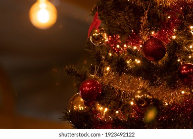 Christmas tree decorated with a garland and various toys