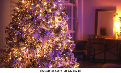 Christmas tree decorated with golden baubles, ribbons and fairy lights is illuminating a cozy living room with purple lights - Powered by Shutterstock