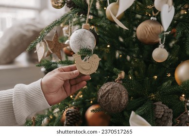 Christmas tree decorations are made by hand from clay. The Christmas tree is decorated with balls and bows in brown and beige colors.  - Powered by Shutterstock