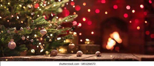 Christmas Tree With Decorations Near A Fireplace with Lights