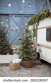 Christmas Tree With Decorations Outdoor Near Travel Trailer. Cozy Christmas Outdoor Decorations