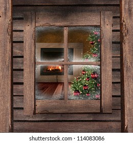 Christmas Tree And Fireplace Seen Through A Wooden Cabin Window