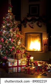 Christmas Tree And Christmas Gift Boxes In The Interior With A Fireplace