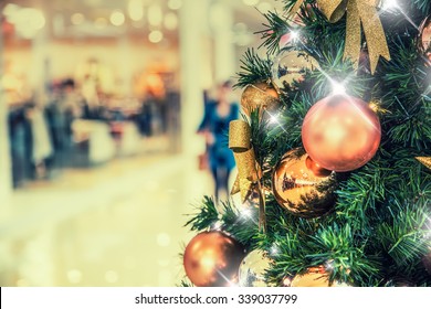 Christmas tree with gold decoration in shopping mall.