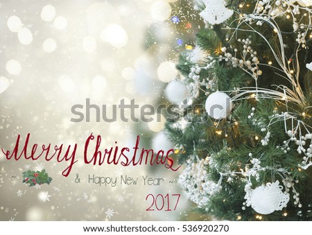 christmas tree with holiday white decorations and lights on silver background and merrychristmas greetings
