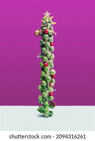 Christmas Tree Inspired Concept. Brussel Sprouts Tree Like Festive Decorated. Minimal Purple And Blue Background