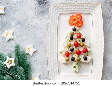 Christmas Tree Made Of Feta Cheese, Vegetables And Microgreens On White Plate. Christmas Dinner Background. Flat Lay