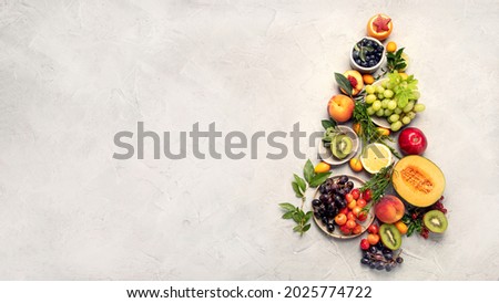 Christmas tree made of fruits on light gray background. New Year Holidays concept. Top view, flat lay, copy space