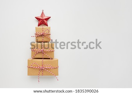Christmas tree made of gift boxes and decorative star on white background. Top view, flat lay, copy space.