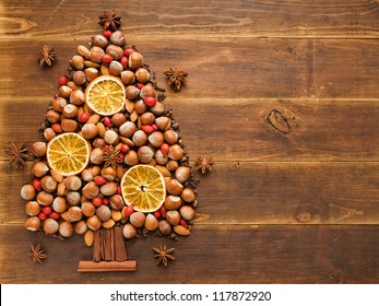 Christmas tree made of nuts, spices and dried oranges. Viewed from above. - Powered by Shutterstock