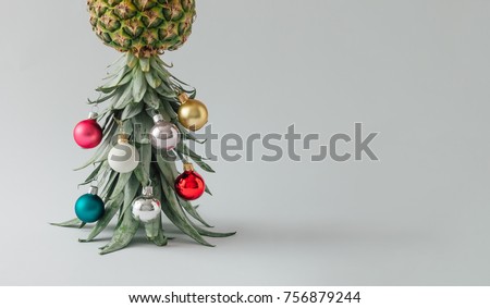 Christmas tree made of pineapple and christmas bauble decoration. Holiday concept.