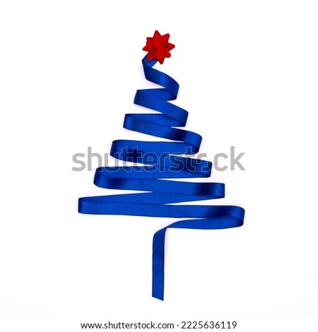 Christmas tree made from royal blue ribbon with red star shape bow isolated on white