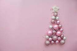 Christmas Tree Made Of Stars, Confetti, Pink Balls On Pink Background. Flat Lay, Top View. Xmas Greeting Card With Text - Merry Christmas.
