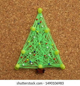 Christmas Tree Made Of Thread And Pins On Cork Board. String Art