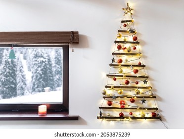 Christmas Tree Made Of Wood Hanging On The Wall, Winter Snowy Landscape Outside The Window