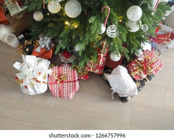 Christmas Tree With Modern Floor And Decoration Full Of Gifts Of Different Kind Underneath Picture Taken From Above.  