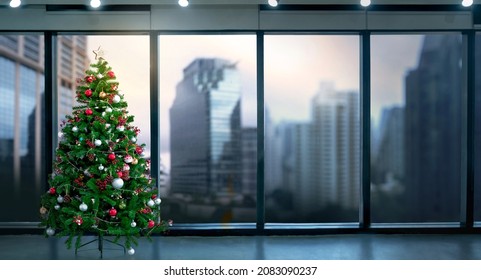 Christmas Tree In Modern Office Near Big Window And Building View In City