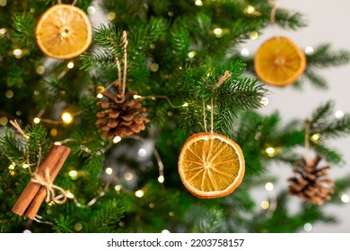 Christmas tree with natural decoration. Dried orange slices, fir cones and cinnamon sticks hanging on Christmas tree. closeup - Powered by Shutterstock