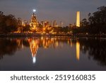 The Christmas tree and the obelisk reflected on the waters of the lake in Ibirapuera Park at night, Sao Paulo, Brazil.