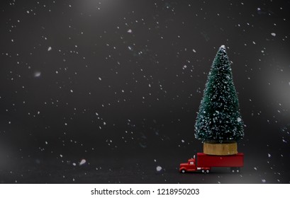 Christmas Tree For Christmas On Red Semi Truck Delivering Christmas Or New Year Gifts In Winter Time.concept For Buy And Shop Decoration On Winter Season.