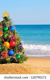 Christmas tree on the sand in the beach - Shutterstock ID 120790171