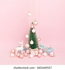 Christmas tree with ornaments over pink background. Minimal picture for winter holidays, xmas and new year celebration greeting card
