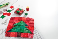 Christmas Tree Patchwork Block, Bright Square Pieces Of Fabric, Pincushion, Quilting And Sewing Accessories On White Background