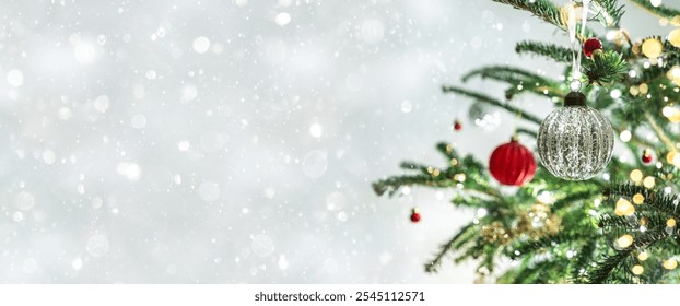 Christmas tree with red Christmas decorations on light background with bokeh, blurred, sparking, glowing. Happy New Year and Xmas card, wide banner - Powered by Shutterstock