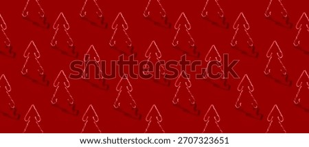Christmas tree shape made of candy canes. Repetitive pattern design on red background
