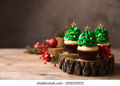 Christmas tree shaped cupcakes on wooden table. Space for text - Powered by Shutterstock