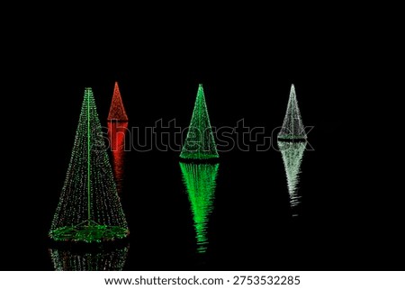Christmas tree shapeed lights seemingly float on the water in McAdenville, North Carolina
