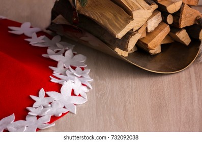 Christmas Tree Skirt And Firewood On Floor At Home