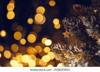  Christmas tree toy in the form of a golden star on a tree. Christmas and New Year decoration, flashing garland, illuminated lamps. Christmas mood background.  - Powered by Shutterstock