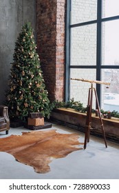 Christmas tree with wooden rustic decorations and presents under it in loft interior.