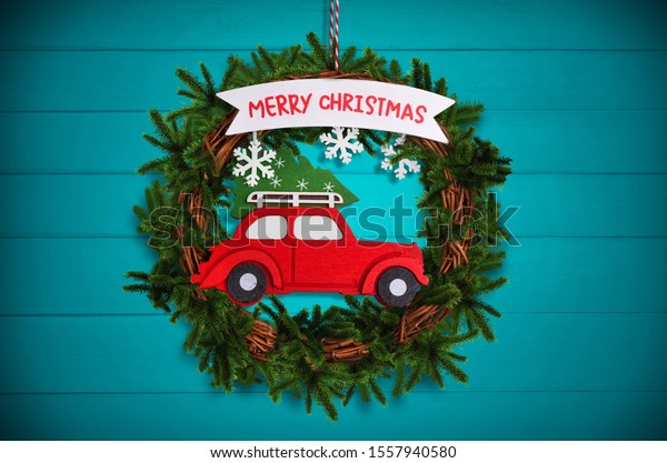 Christmas tree wreath\
with red car\
background