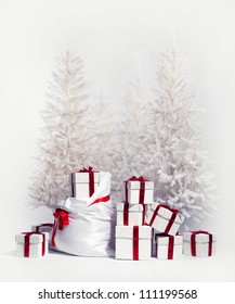 Christmas trees with heap of gift boxes over white background