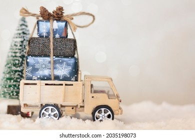 Christmas Truck With Christmas Gifts On Snowy Road With Christmas Tree On The Background