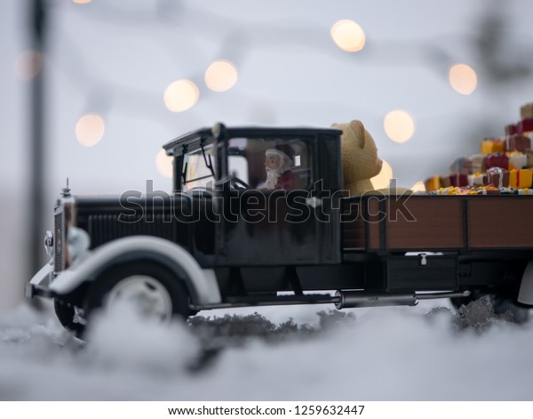 Christmas truck with loaded gifts and\
bear. Christmas teddy bear and gifts loaded on a\
car.