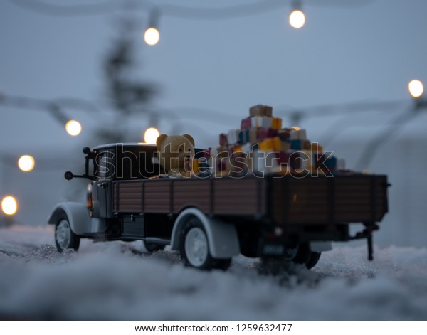 Christmas truck with loaded gifts and
bear. Christmas teddy bear and gifts loaded on a
car.