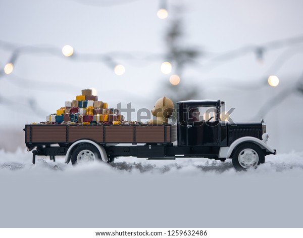 Christmas truck with loaded gifts and\
bear. Christmas teddy bear and gifts loaded on a\
car.