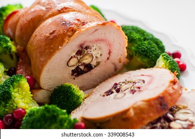 Christmas Turkey Breast Roll Stuffed With Cheese, Hazelnuts, Cranberries And Herbs, Close Up