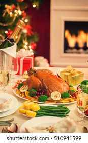 Christmas Turkey Dinner In Front Of Christmas Tree Near Fireplace 