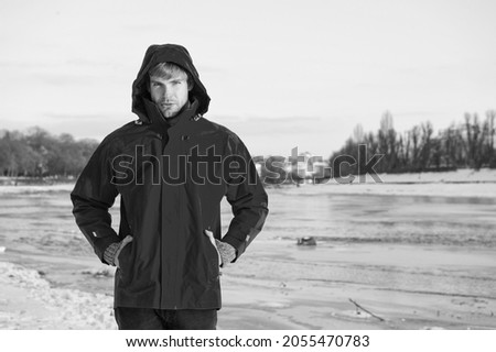 Christmas vacation. human and nature. man walking snowy landscape in sunset. travel and expedition concept. man in red parka. winter male fashion. warm clothes for cold climate. weather forecast