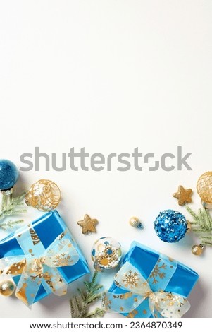 Christmas vertical banner design. Flat lay blue and gold gift boxes, baubles, fir branches on white background. Top view with copy space.