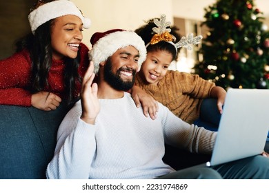 Christmas, video call and laptop with family in living room for communication, connectivity and celebration. Internet, technology and online with parents and child wave for holiday, festive and xmas - Powered by Shutterstock