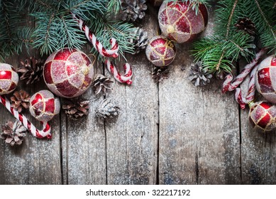 Christmas Vintage Fir Tree Toys, Red Balls, Coniferous, Candy Cane, Pine Cones as Decor on Wooden Planks - Powered by Shutterstock