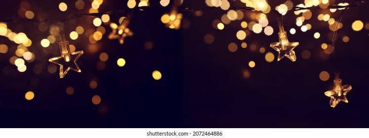 Christmas Warm Gold Garland Lights Over Dark Background With Glitter Overlay