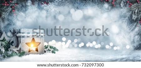 Christmas wide background in silver blue colors with a lantern, fir branches, ornaments and out of focus lights